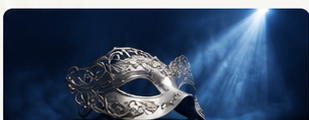 A masquerade mask under a spotlight
